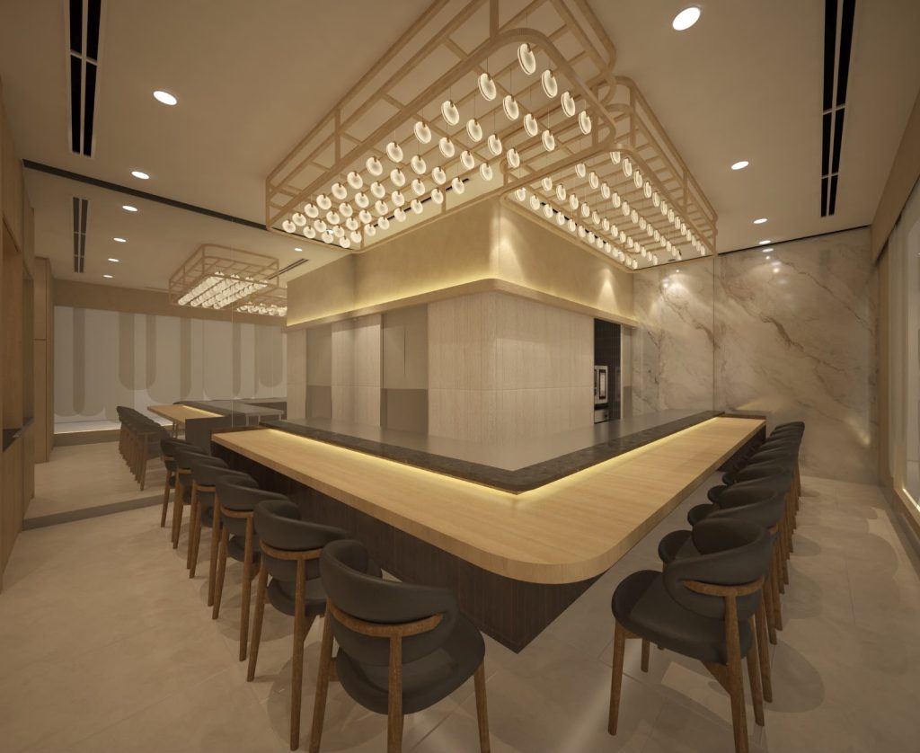 The L-shaped wooden omakase counter at Shiori Omakase, lit by pendant lights