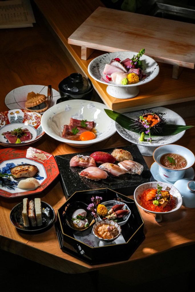 A Shiori omakase spread of nigiri, sashimi, uni in the shell, ikura and wagyu sando on the counter